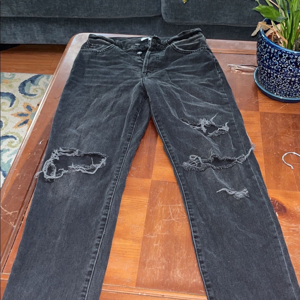 Ripped jeans, three buttons in the front.